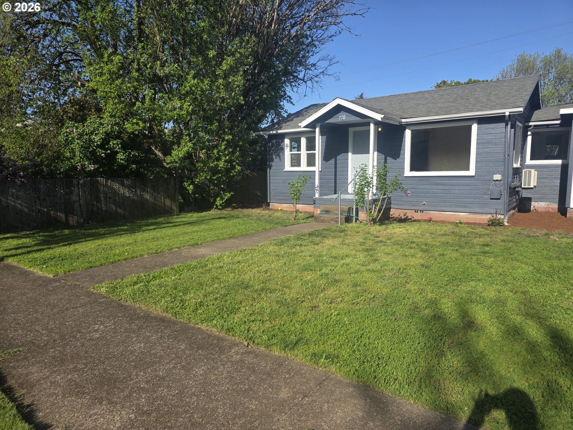 770 Elm Street Junction City, OR 97448 - Photo 2 of 30 a front view of a house with a garden and yard