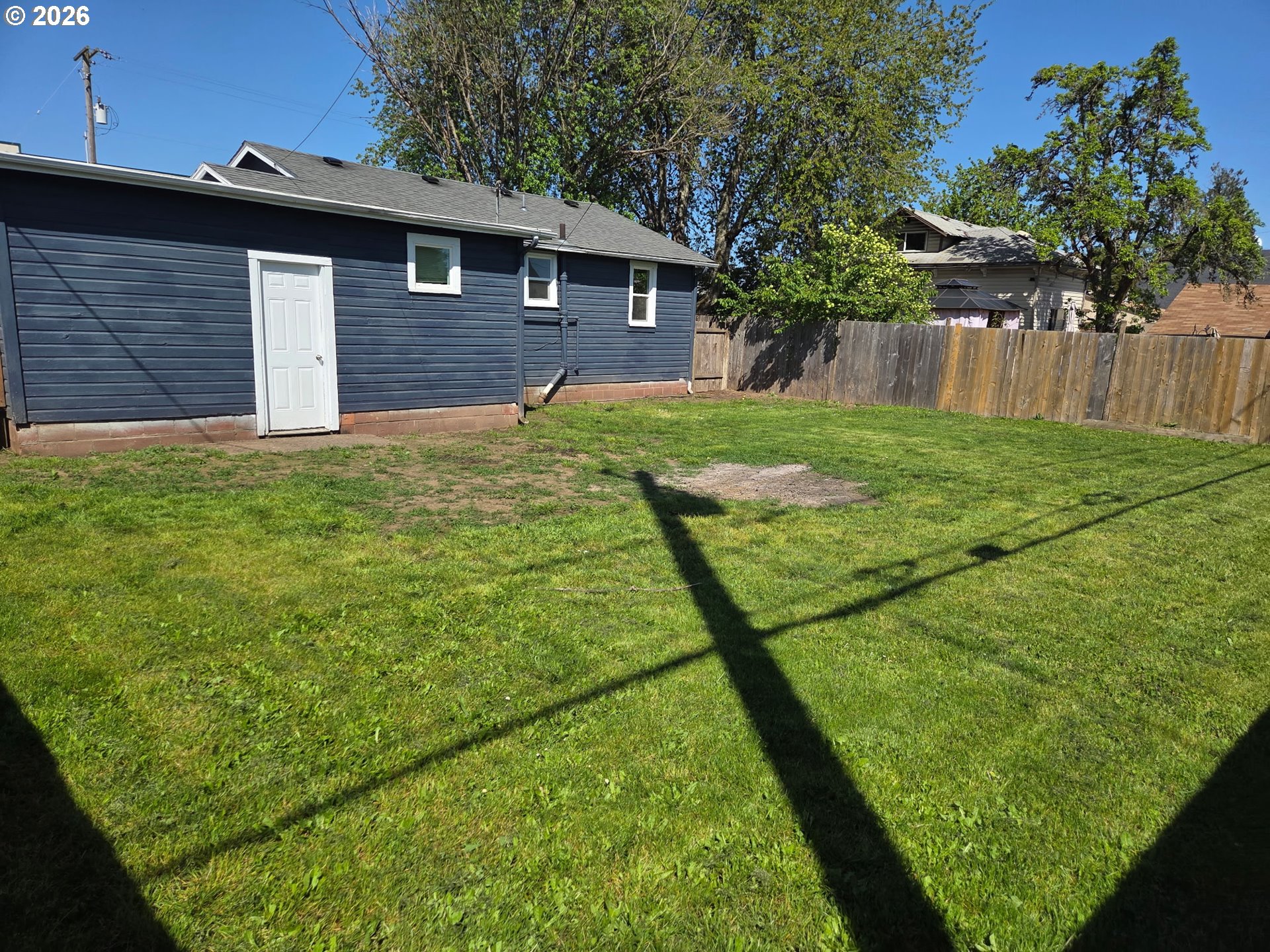 770 Elm Street Junction City, OR 97448 - Photo 29 of 30 a backyard of a house with plants and wooden fence
