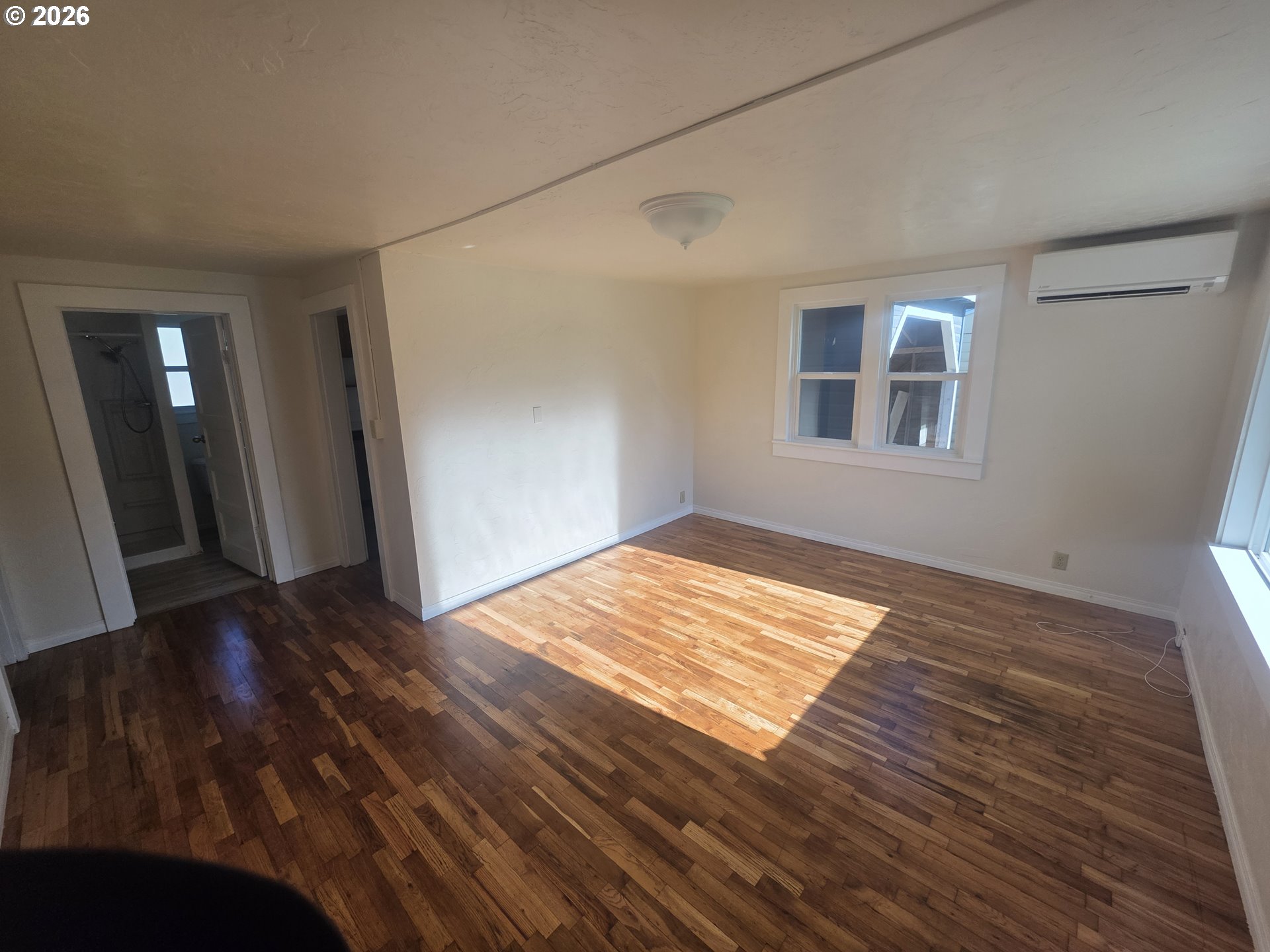 770 Elm Street Junction City, OR 97448 - Photo 5 of 30 a view of an empty room with wooden floor and a window
