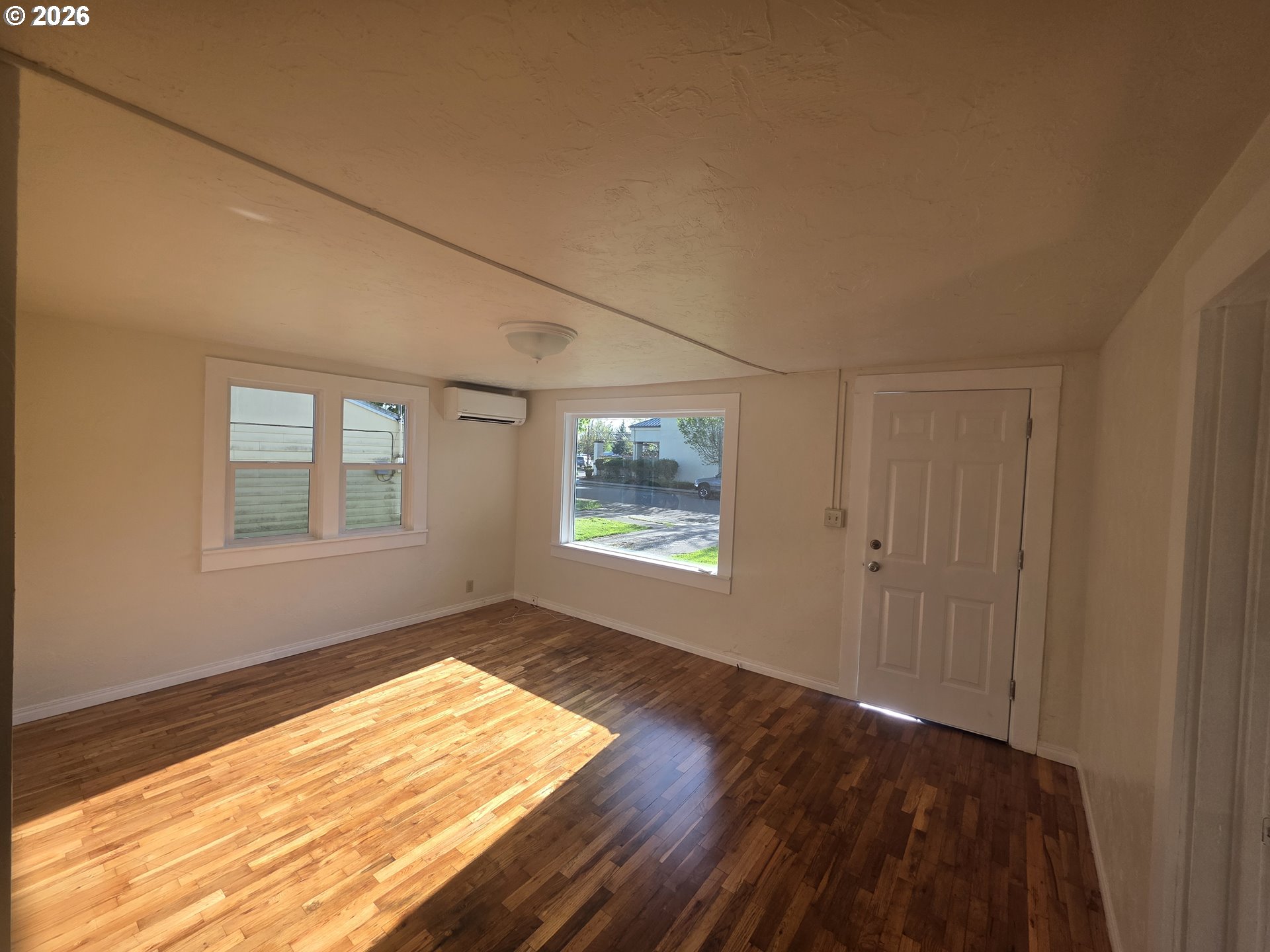 770 Elm Street Junction City, OR 97448 - Photo 6 of 30 a view of an empty room with wooden floor and a window