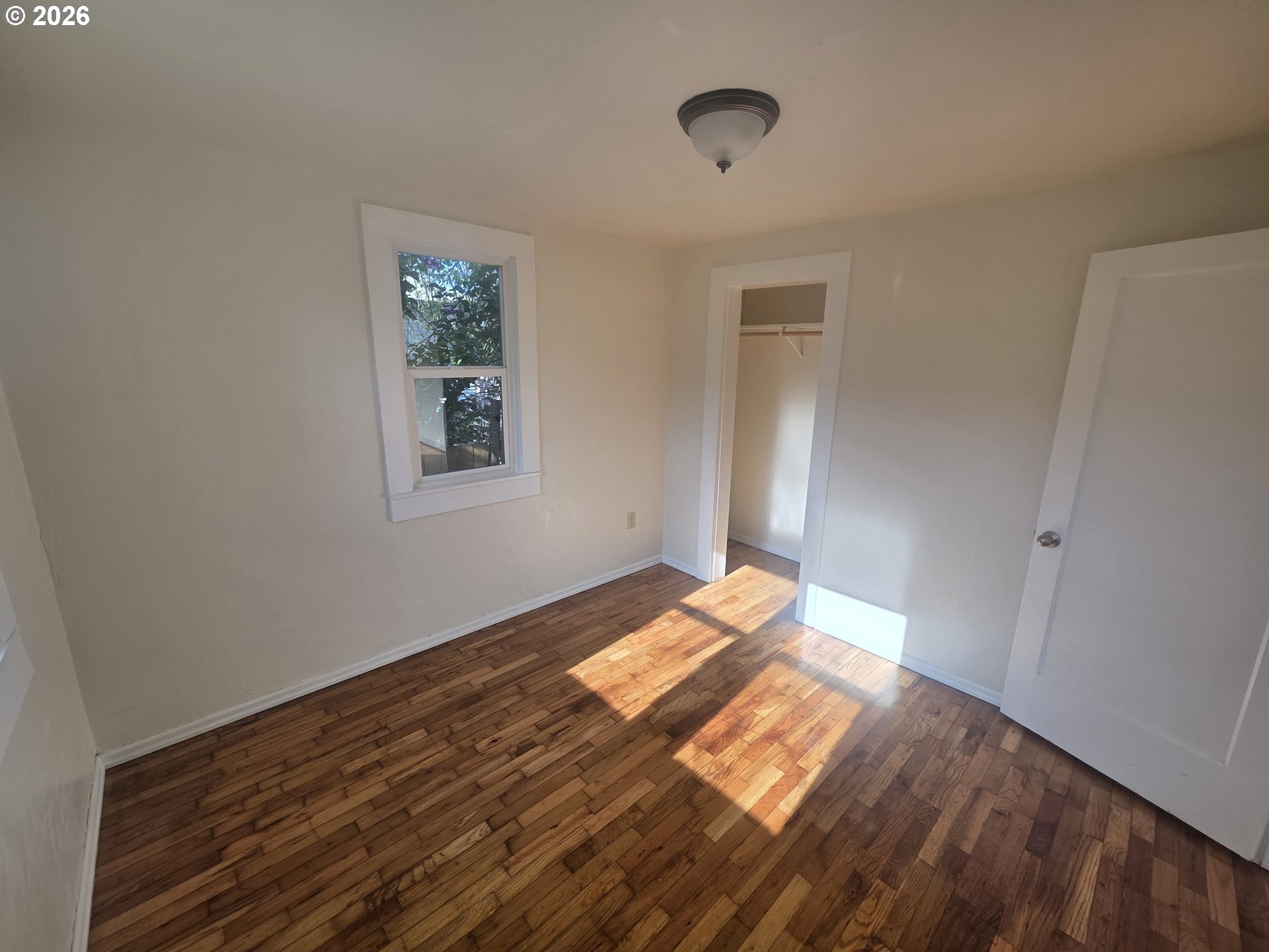 770 Elm Street Junction City, OR 97448 - Photo 9 of 30 a view of empty room with wooden floor and fan