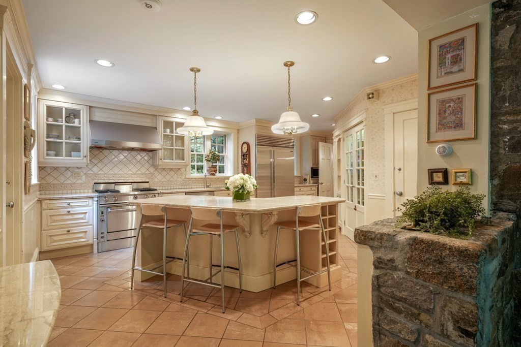 110 Hundreds Road Wellesley, MA 02481 - Photo 16 of 42 a kitchen with stainless steel appliances granite countertop a stove and a refrigerator