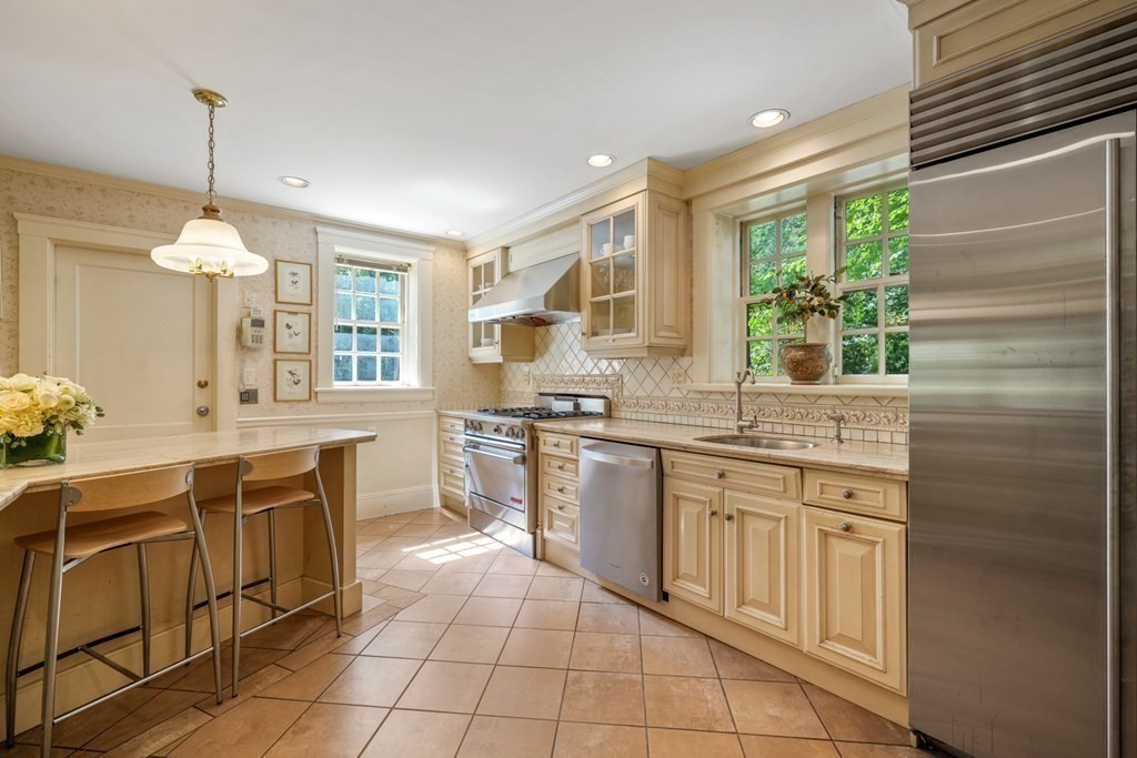 110 Hundreds Road Wellesley, MA 02481 - Photo 17 of 42 a kitchen with a sink stove and cabinets