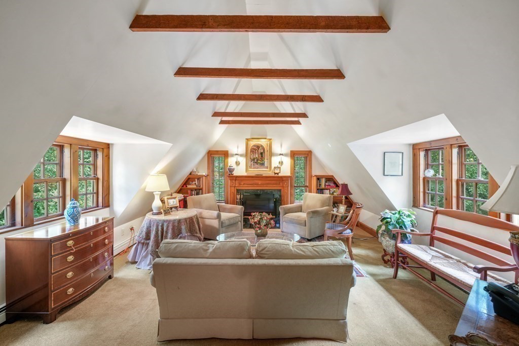 110 Hundreds Road Wellesley, MA 02481 - Photo 26 of 42 a living room with furniture a fireplace and a large window