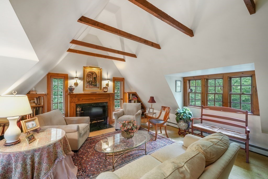 110 Hundreds Road Wellesley, MA 02481 - Photo 27 of 42 a living room with furniture a fireplace and a floor to ceiling window
