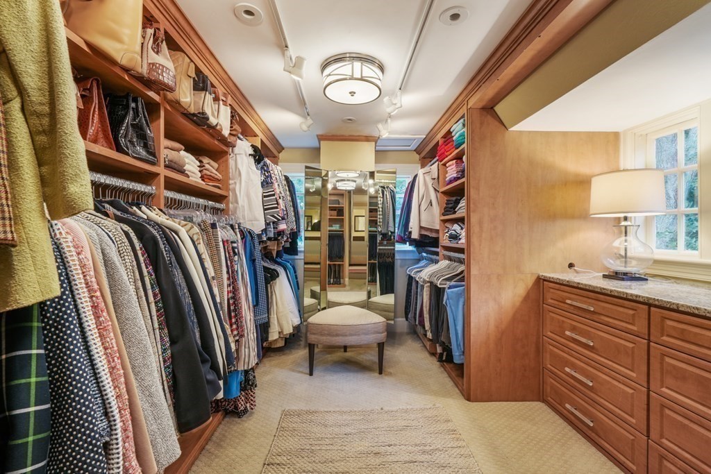 110 Hundreds Road Wellesley, MA 02481 - Photo 31 of 42 a view of walk in closet with clothes and shoes