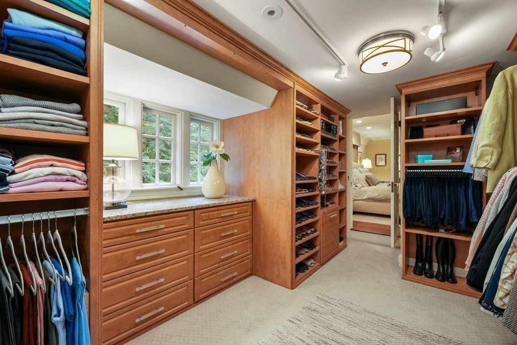 110 Hundreds Road Wellesley, MA 02481 - Photo 32 of 42 a view of walk in closet with clothes and shoes