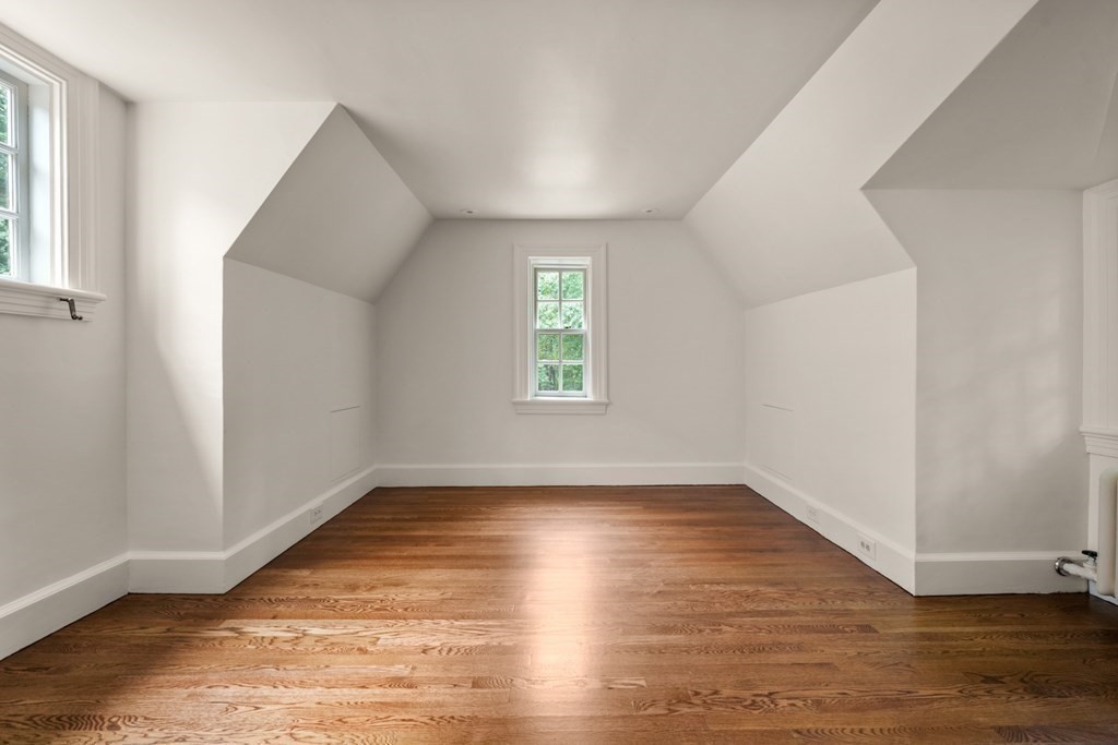 110 Hundreds Road Wellesley, MA 02481 - Photo 36 of 42 an empty room with wooden floor and windows