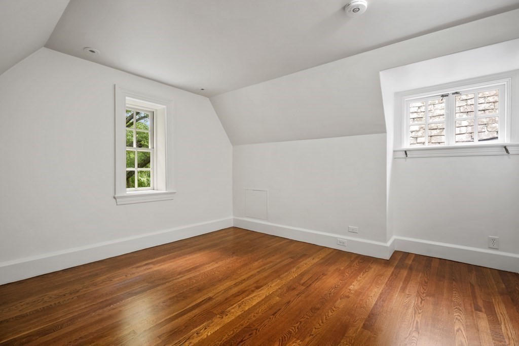 110 Hundreds Road Wellesley, MA 02481 - Photo 37 of 42 an empty room with wooden floor and windows