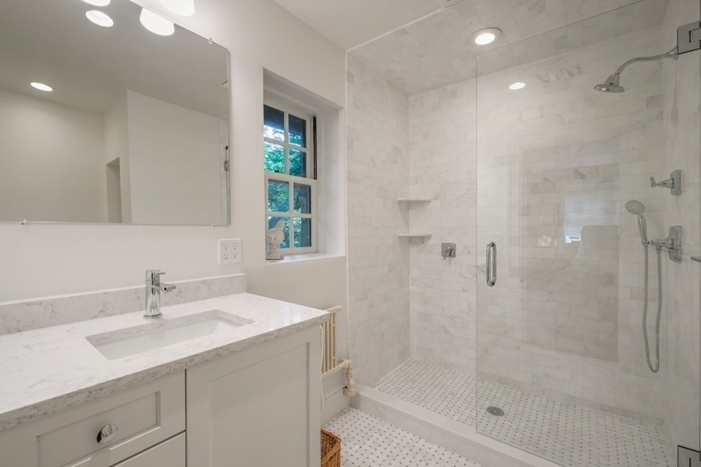 110 Hundreds Road Wellesley, MA 02481 - Photo 39 of 42 a bathroom with a shower sink and a mirror