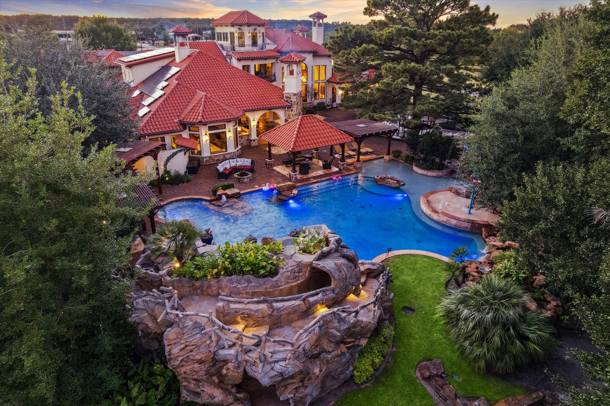 An entertainer’s paradise! This Mediterranean estate features a resort-style pool with waterfalls, spa, and swim-up seating, plus a covered outdoor kitchen and cabana for effortless gatherings. Expansive terraces, multiple balconies, and manicured grounds create the ultimate luxury retreat for hosting events or enjoying private relaxation.