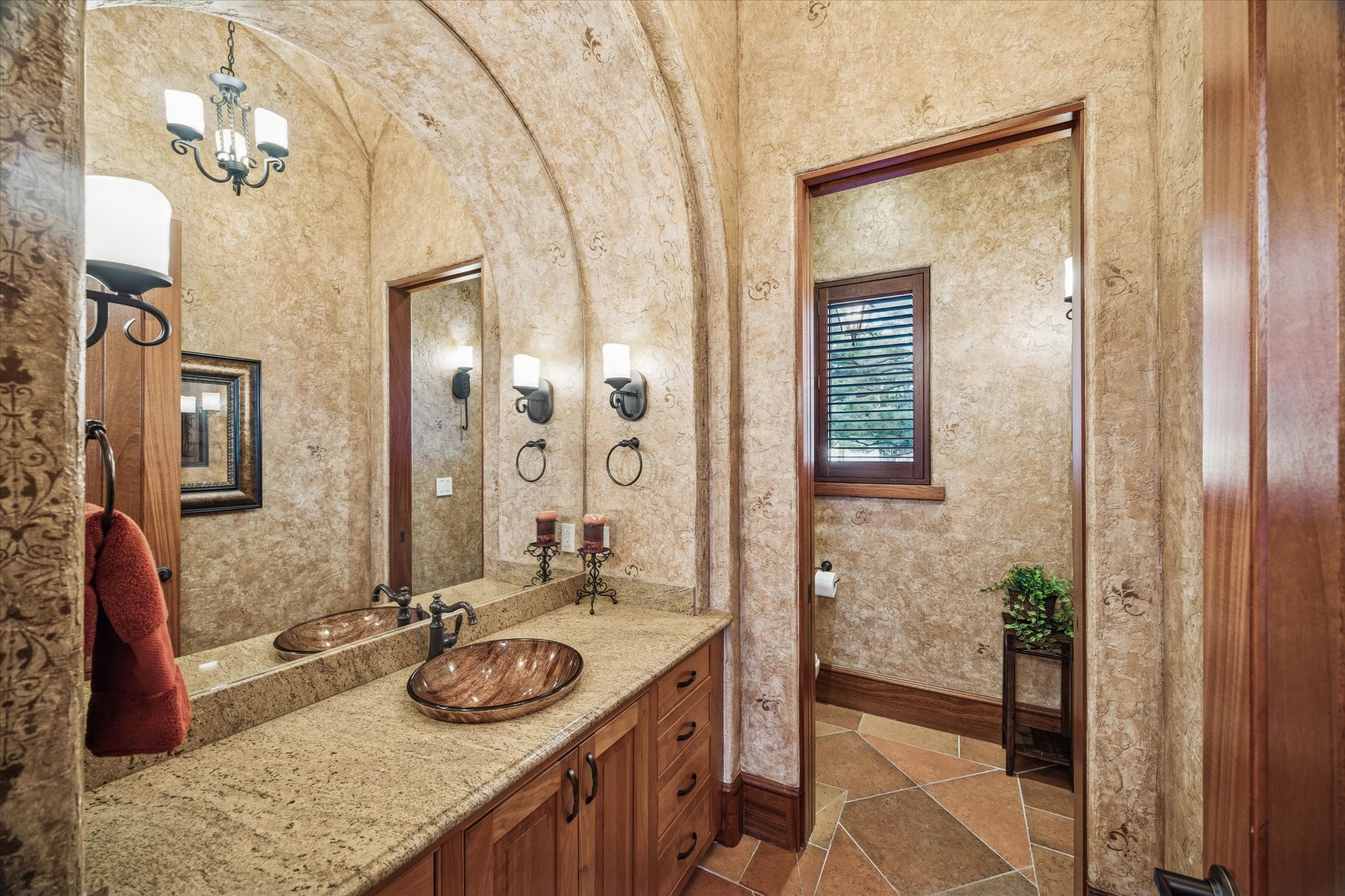21538 Mueschke Road Tomball, TX 77377 - Photo 29 of 50 Powder room. Located in the west wing of the home just before the primary suite, this beautifully appointed powder room offers a serene and refined space for guests. The expansive vanity with ample cabinet storage keeps essentials organized, while stunning granite countertops and sophisticated finishes create an atmosphere of understated luxury.