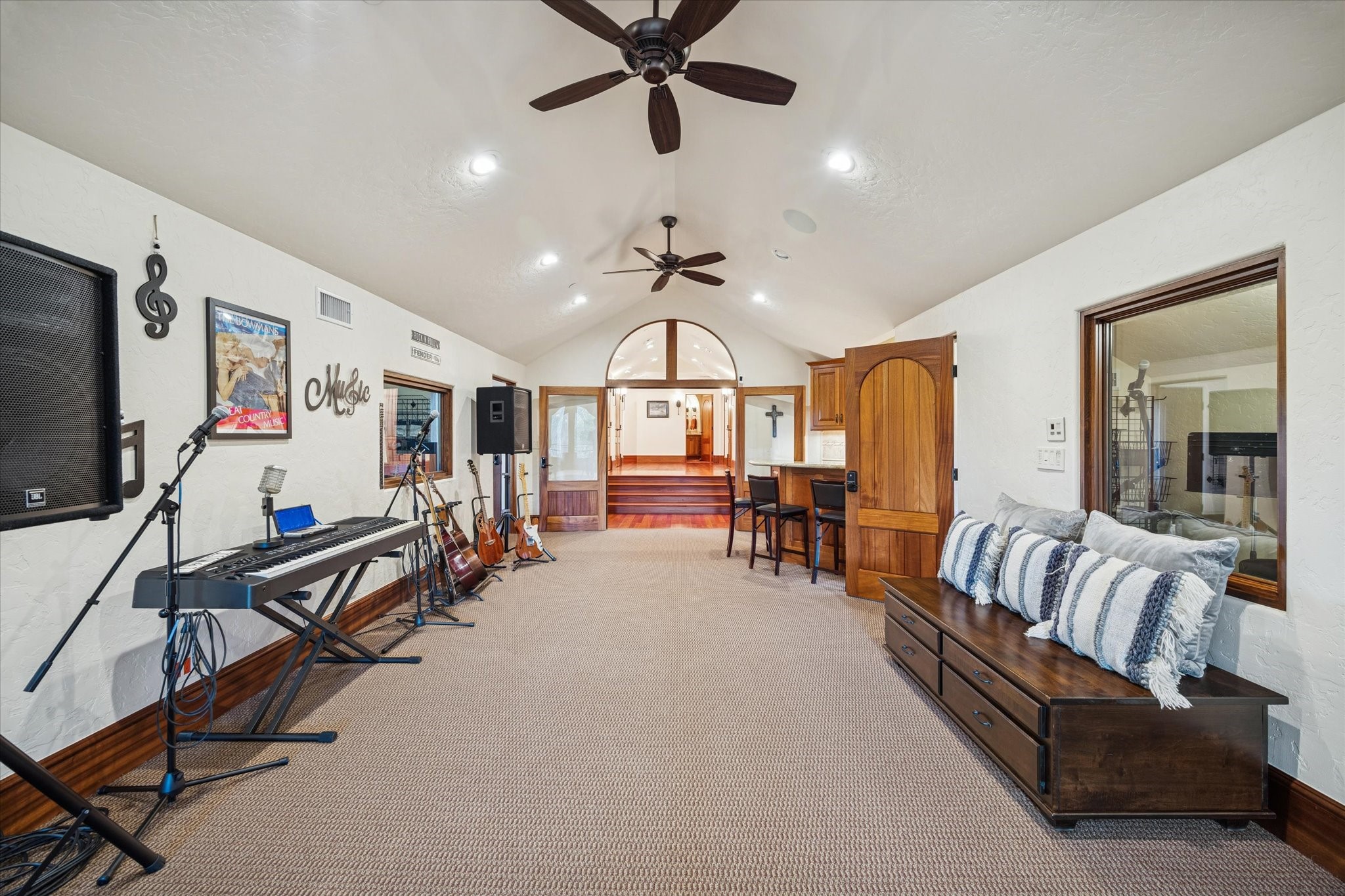 21538 Mueschke Road Tomball, TX 77377 - Photo 33 of 50 Music and creative prelude. This spacious anteroom to the music studio offers ample space for instruments and seating, with a view of the bar area. Perfect for music and art enthusiasts, it provides a refined and inspiring setting to create, gather, and enjoy memorable moments in a truly special space.