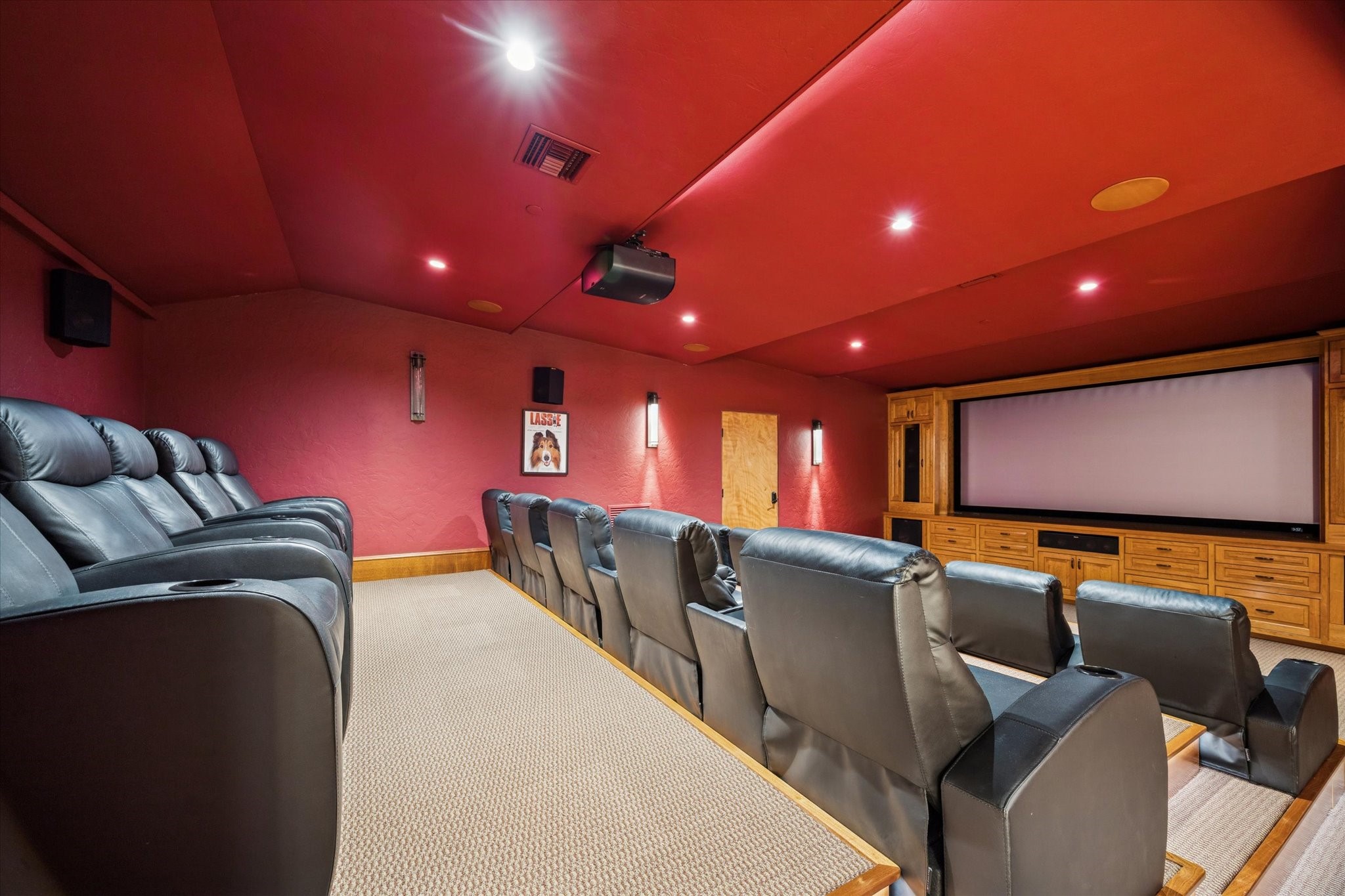 21538 Mueschke Road Tomball, TX 77377 - Photo 34 of 50 Spacious media room. Imagine cozy movie nights or lively gatherings in this generously sized media room, located on the second floor next to the music space and bar. With ample seating for family and friends, a full bathroom nearby for convenience, and abundant storage along the hallway, this space is designed for effortless entertaining and creating unforgettable moments in comfort and style.