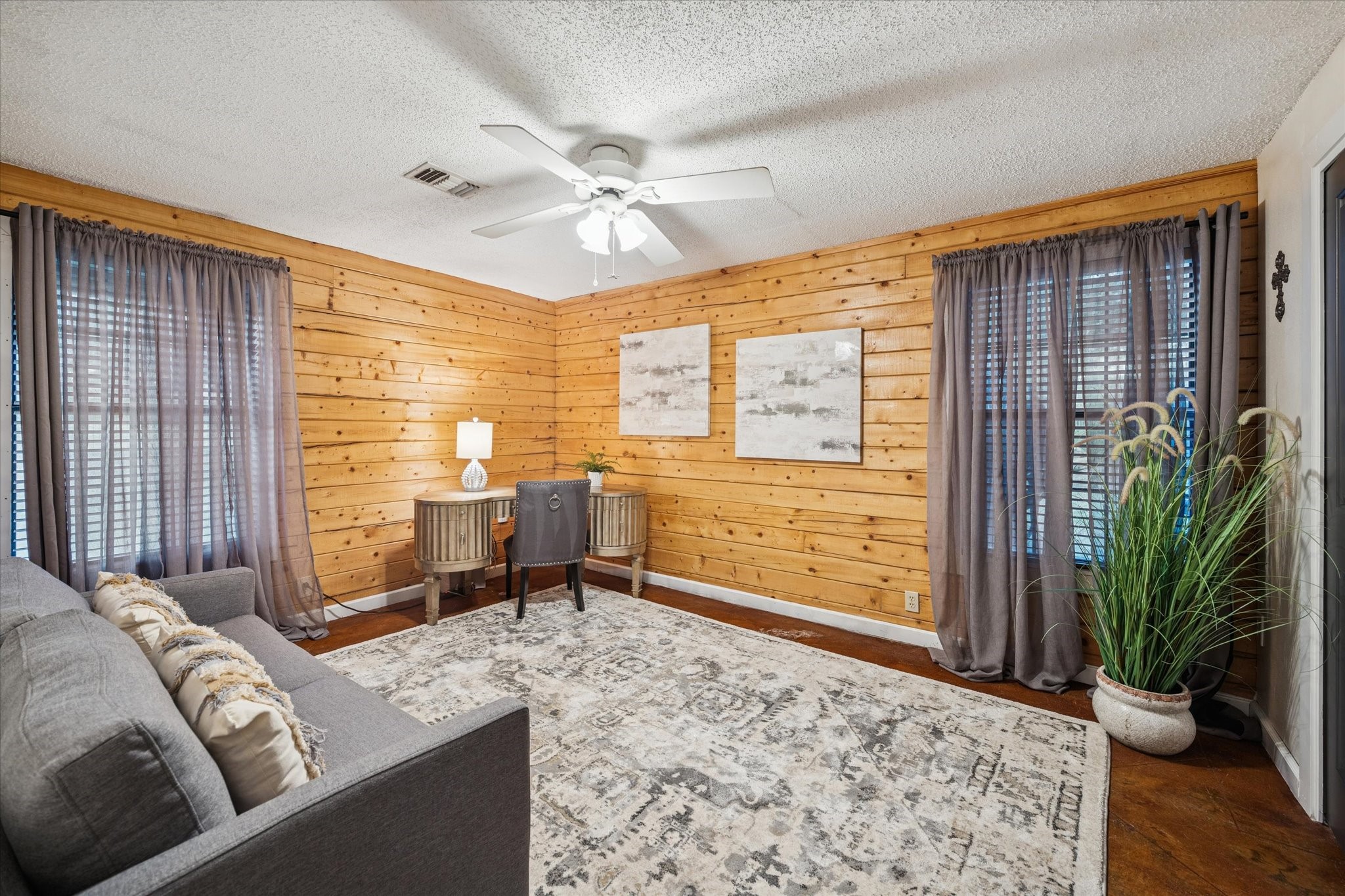 21538 Mueschke Road Tomball, TX 77377 - Photo 43 of 50 Third bedroom in the log cabin. Part of the spacious 1,680 sq. ft. cabin, this inviting room offers comfort and generous space, making it the perfect independent guest cottage. Surrounded by nature, it provides a serene and private retreat for family or visitors.