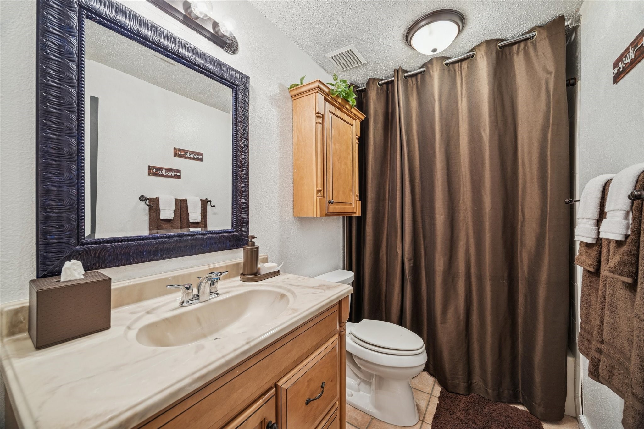 21538 Mueschke Road Tomball, TX 77377 - Photo 44 of 50 Both bathrooms are thoughtfully designed, combining functionality with rustic touches, while the loft overlooks the main living area, adding a sense of openness and charm.