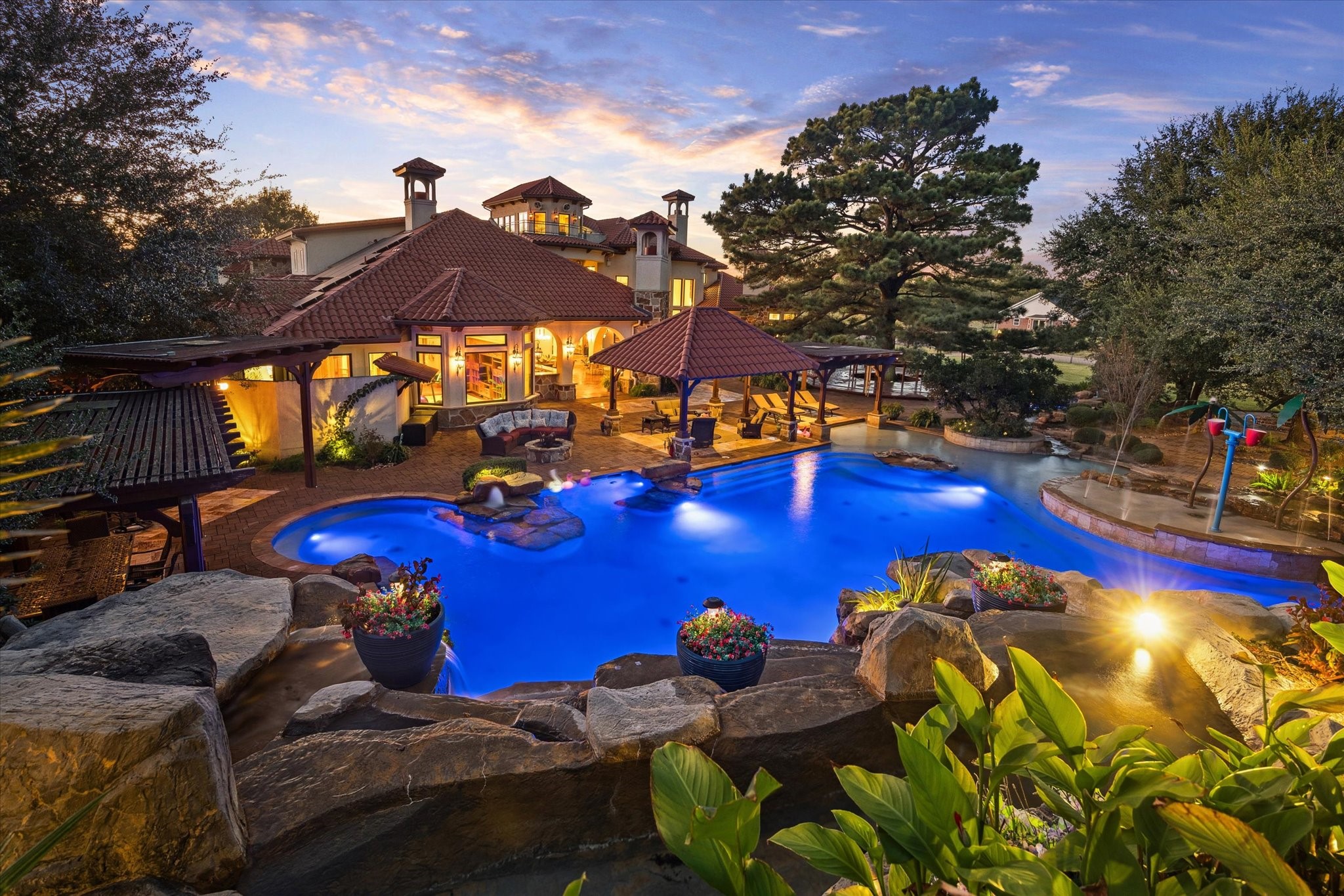 21538 Mueschke Road Tomball, TX 77377 - Photo 49 of 50 Experience the ultimate in luxury retreat and outdoor living. Dive into a resort-style pool inspired by waterparks, featuring dramatic rock waterfalls, a built-in spa, and swim-up seating for effortless relaxation. Entertain in style with shaded cabanas and a fully equipped outdoor kitchen—perfect for hosting unforgettable gatherings.