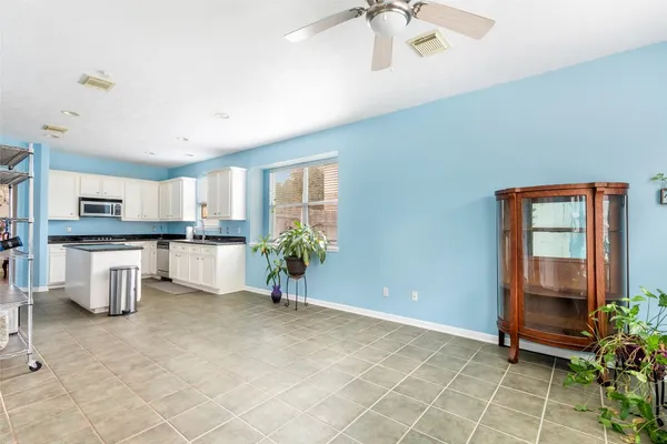 a view of a kitchen with furniture and a potted plant