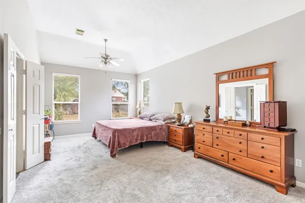 a spacious bedroom with a bed and window