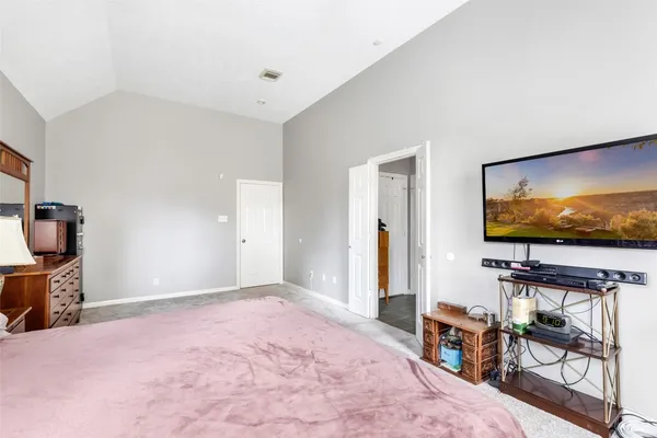 a living room with furniture flat screen tv and gym equipment