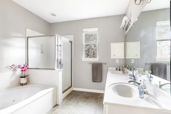 a bathroom with a sink mirror and a bathtub