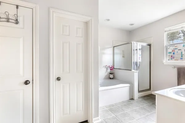 a bathroom with bathtub and shower