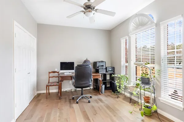 a view of a workspace with furniture and a window