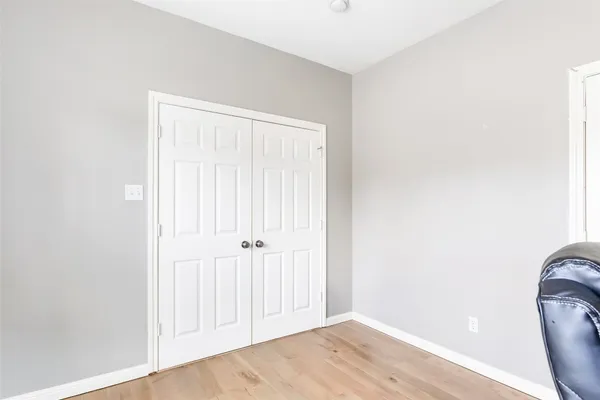 a view of a room with wooden floor