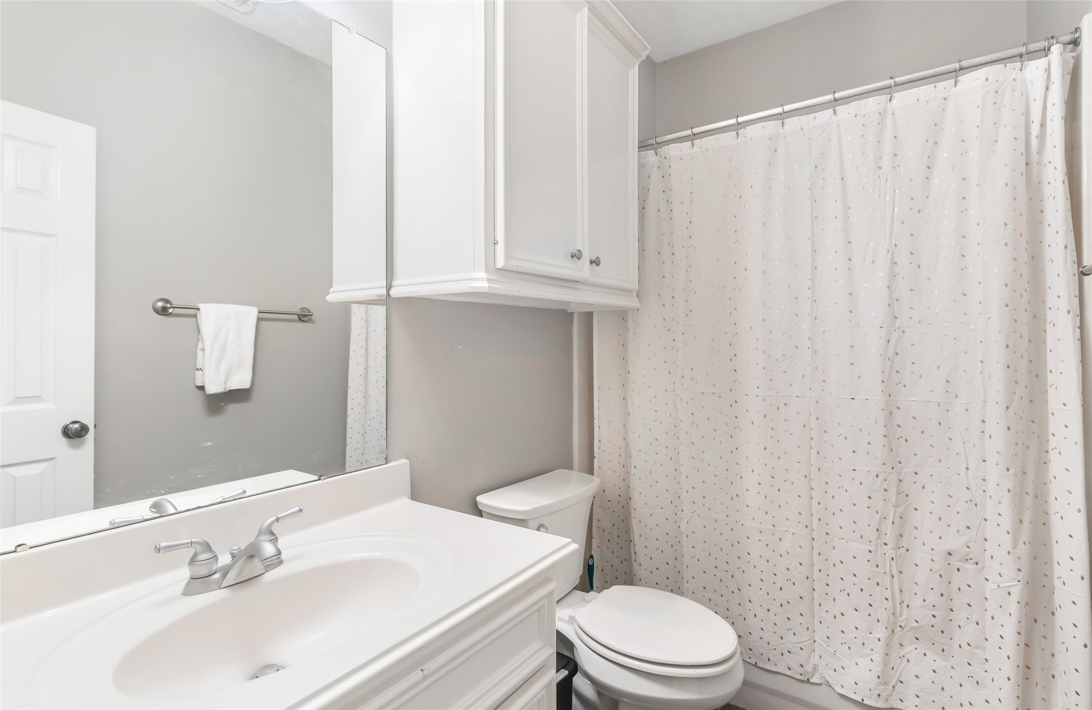3504 Oak Landing Conroe, TX 77304 - Photo 24 of 29 a bathroom with a sink a toilet and shower curtain