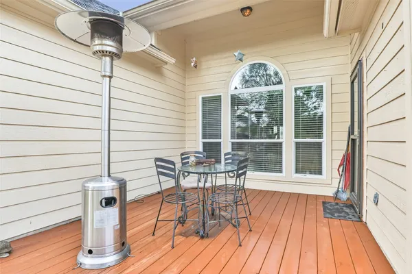 a view of a roof deck with table and chairs and wooden floor