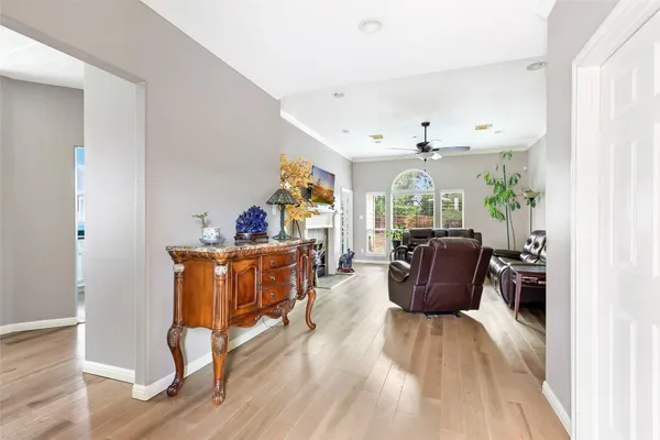 a living room with furniture and a wooden floor