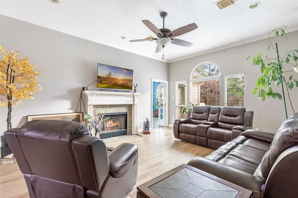 a living room with furniture a fireplace and a large window