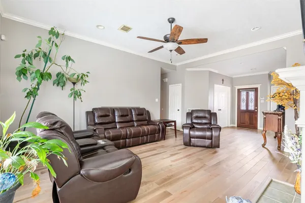 a living room with furniture and a potted plant