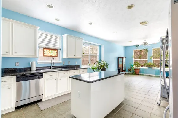 a kitchen with sink cabinets and window