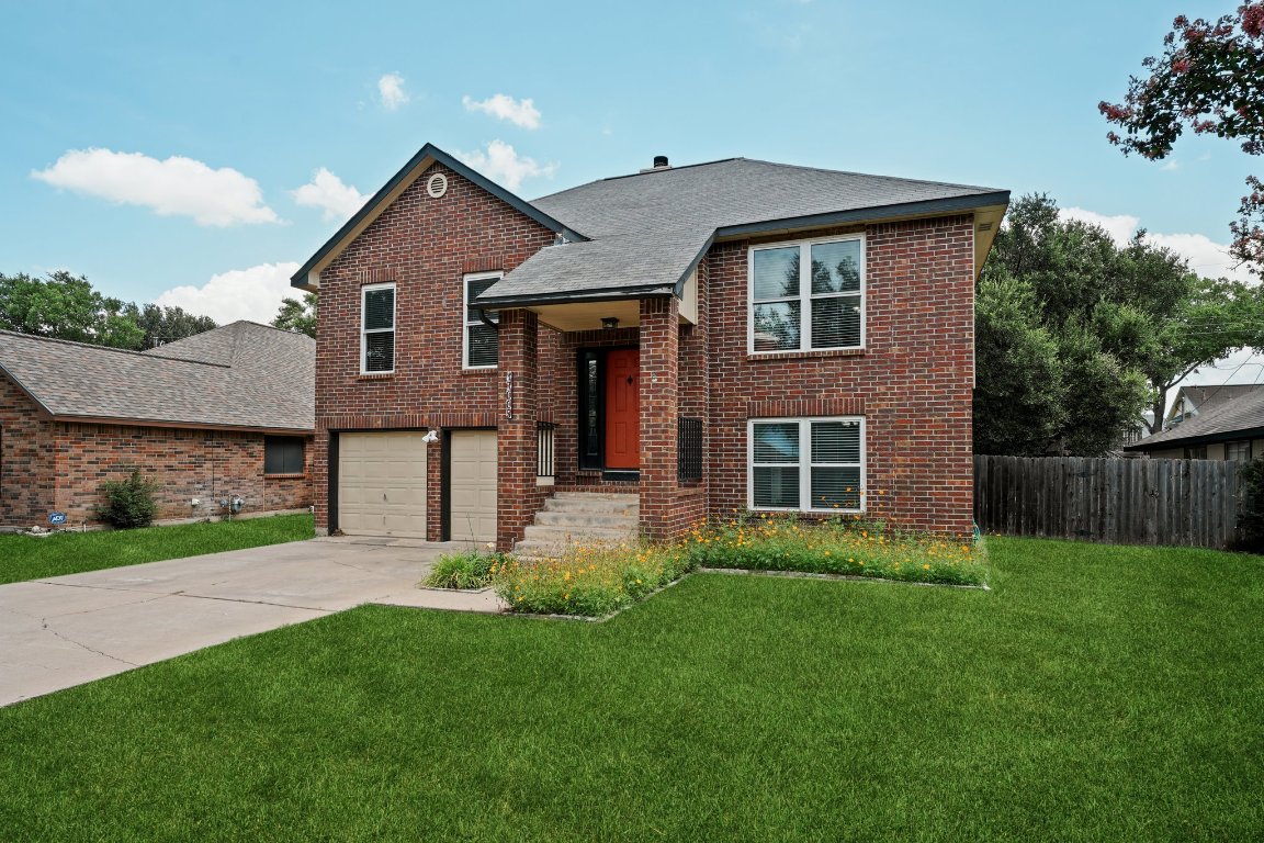 17005 Simsbrook Drive Pflugerville, TX 78660 - Photo 1 of 1 a front view of a house with a yard and garage