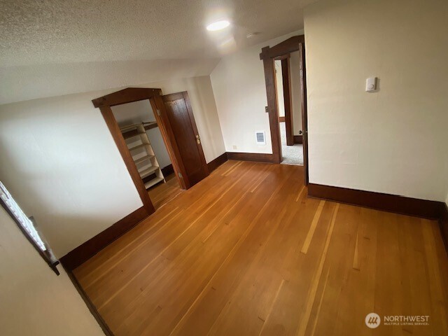 790 East Badger Road Lynden, WA 98264 - Photo 13 of 26 a view of an empty room with wooden floor and closet
