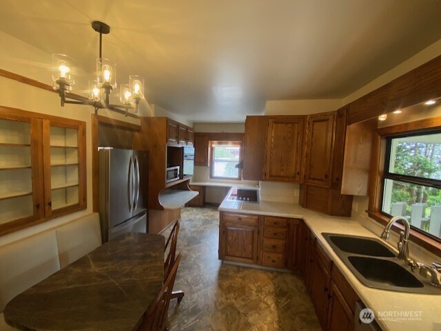 790 East Badger Road Lynden, WA 98264 - Photo 7 of 26 a kitchen with counter top space a sink and stainless steel appliances