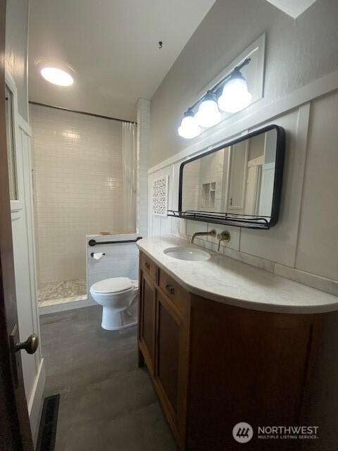 790 East Badger Road Lynden, WA 98264 - Photo 8 of 26 a bathroom with a granite countertop sink a mirror and toilet
