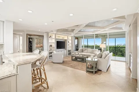a dining room with furniture a chandelier and wooden floor