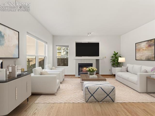 7590 Julynn Road Colorado Springs, CO 80919 - Photo 21 of 44 Virtually Staged - Living room featuring light hardwood / wood-style floors and a tile fireplace