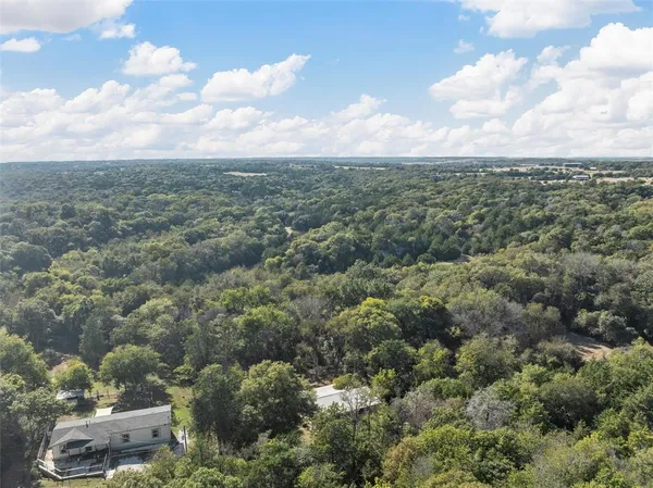 a backyard of a house with yard fire pit barbeque oven and outdoor seating