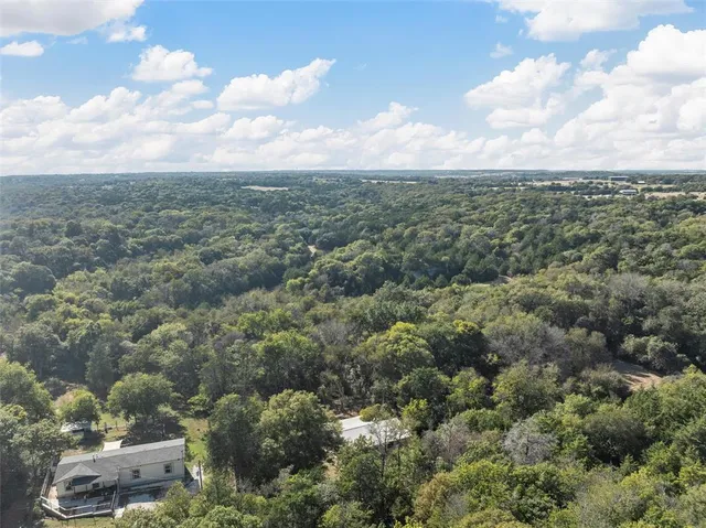 a backyard of a house with yard fire pit barbeque oven and outdoor seating
