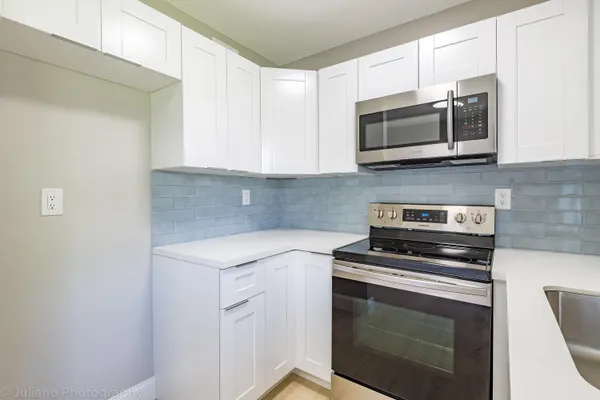 a kitchen with a stove and a microwave