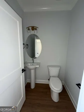 a bathroom with a toilet and a mirror