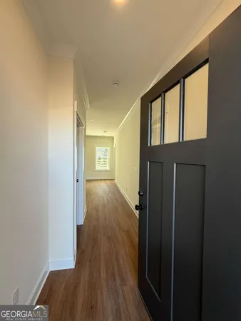 a view of hallway with wooden floor
