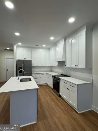 a kitchen with a sink stove and refrigerator