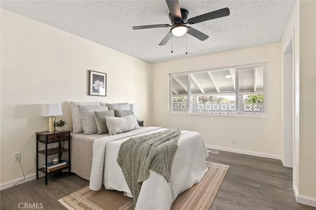 a view of a hallway with wooden floor and a bathroom