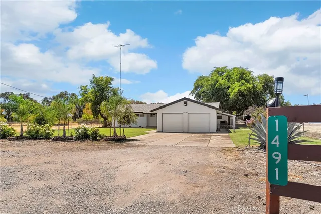 a view of a hallway with wooden floor and a bathroom