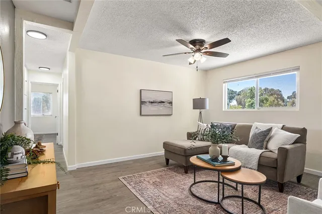 a living room with furniture and a wooden floor