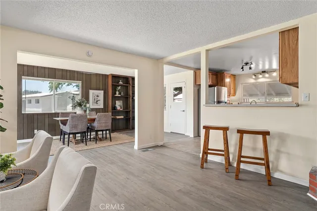 a kitchen with stainless steel appliances granite countertop a sink and dishwasher a stove top oven with wooden floor